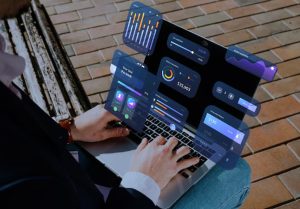 Person using a laptop with financial dashboards and graphs overlaid, representing digital tools to automate your finances efficiently in 2025.