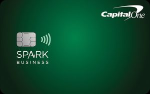 Green Spark Business credit card from Capital One displayed on a gradient green background. The card features a contactless payment symbol, an embedded chip on the left side, the ‘Spark Business’ branding, and the Capital One logo in the upper-right corner. The minimalist design highlights a professional business credit card focused on simple cash-back rewards and everyday spending for small businesses.